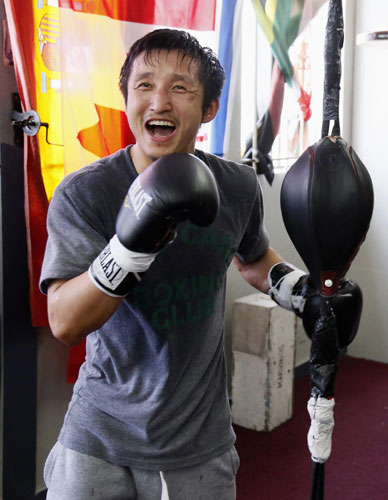 Two-time Olympic gold medalist and three-time world amateur boxing champion Zou Shiming of China laughs as he works out at the Wild Card Boxing Club while preparing for his upcoming professional boxing debut, in Los Angeles, March 20, 2013.