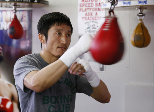 Two-time Olympic gold medalist and three-time world amateur boxing champion Zou Shiming of China works out on the speed bag at Wild Card Boxing Club while preparing for his upcoming professional boxing debut, in Los Angeles, March 20, 2013. 