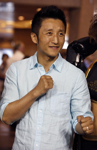 Chinese boxer Zou Shiming poses during a promotional event in Hong Kong, March 27, 2013.