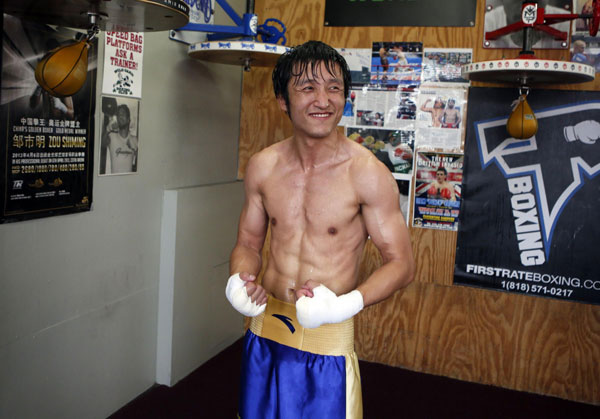 Boxer Zou Shiming of China smiles after training for his upcoming bout against Jesus Ortega of Mexico in Hollywood, California, July 11, 2013.