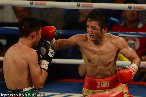 Zou Shiming, right, fights Mexico's Jesus Ortega during a six-round flyweight bout in Macao, China, July 27, 2013.