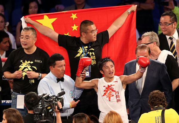 Zou Shiming, front, celebrates after defeating Mexico's Jesus Ortega in Macao, China, July 27, 2013.