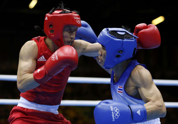 Zou Shiming won his second successive Olympic gold medal on Saturday, beating Thailand's Kaeo Pongprayoon in a battle of two of the oldest fighters.