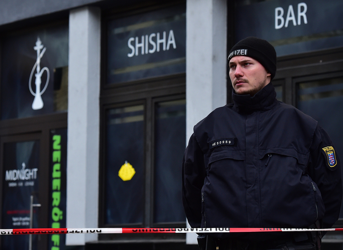 a policeman is on duty outside a shisha bar in hanau