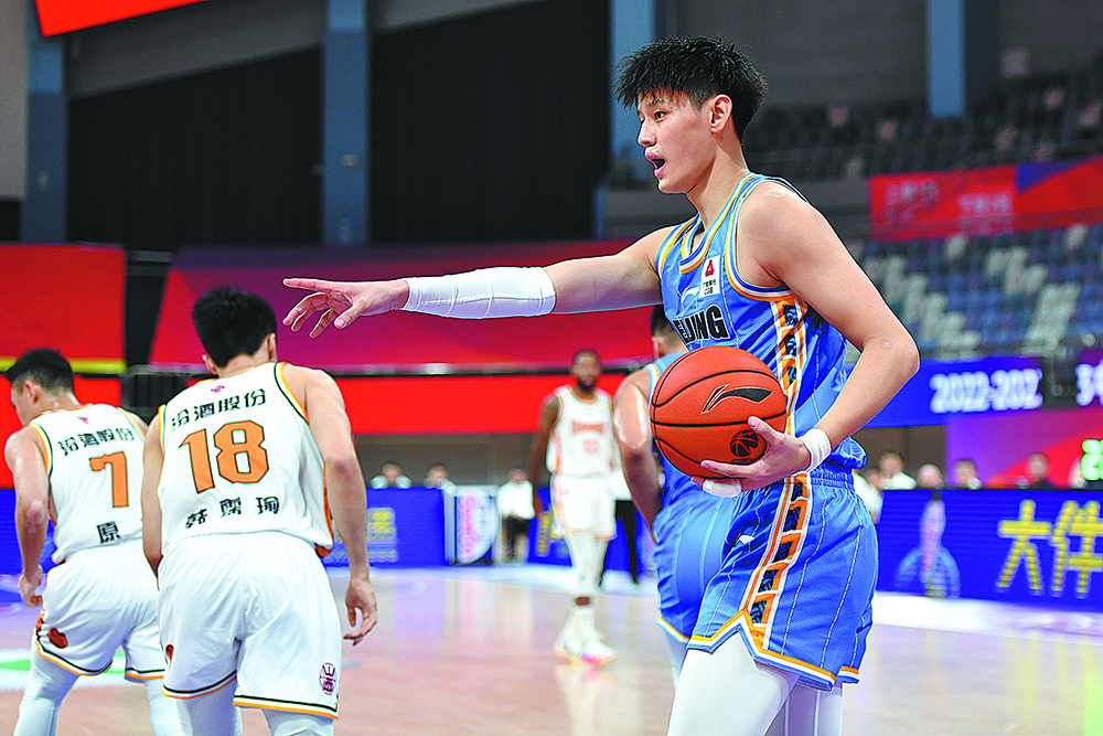 Beijing, China. 19th Mar, 2023. Zeng Fanbo (L) of Beijing Ducks goes for a  lay up during the 37th round match between Beijing Ducks and Shandong  Heroes at 2022-2023 season of the