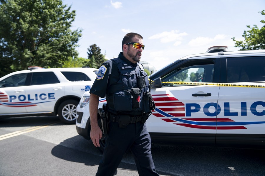 home>/world>/americas>a police officer works near the capitol