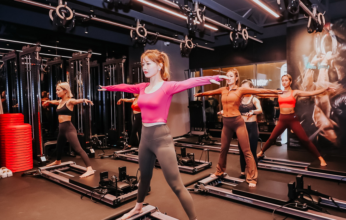 members take a pilates class at a pure yoga studio in shanghai